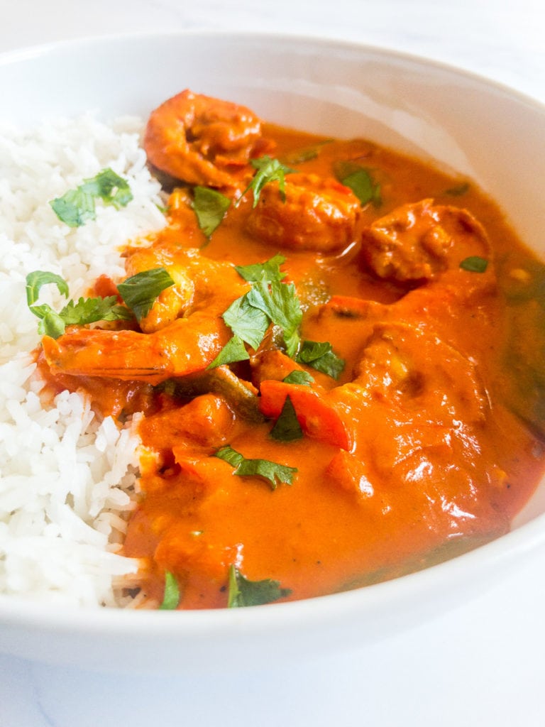 indian shrimp curry with rice in a white bowl