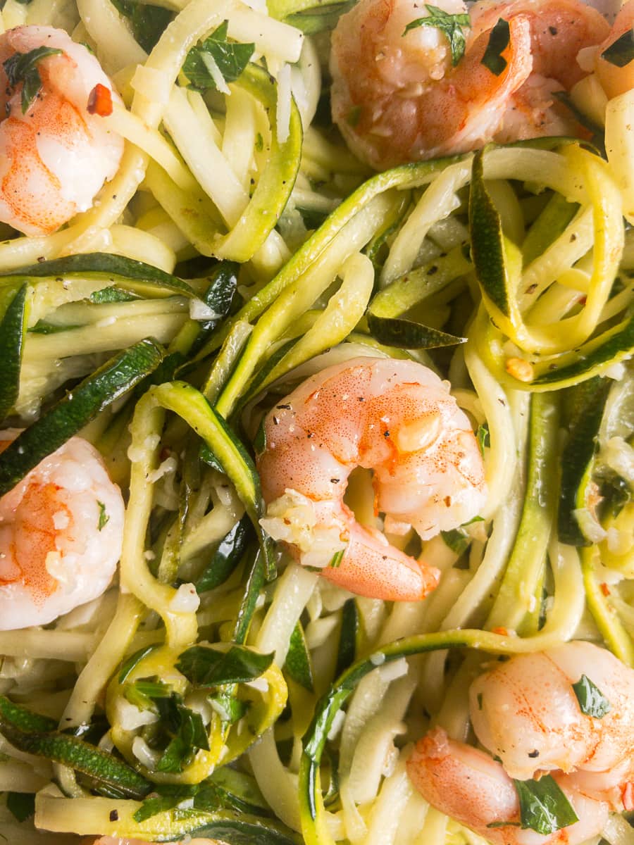zucchini noodles with garlic shrimp on a white plate