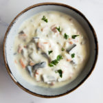 mediterranean garlic yogurt sauce with carrot and eggplant in a small bowl with parsley