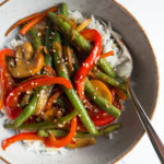 ginger soy vegetable stir fry and rice in a bowl with a fork