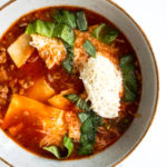 easy lasagna soup topped with fresh basil in a bowl