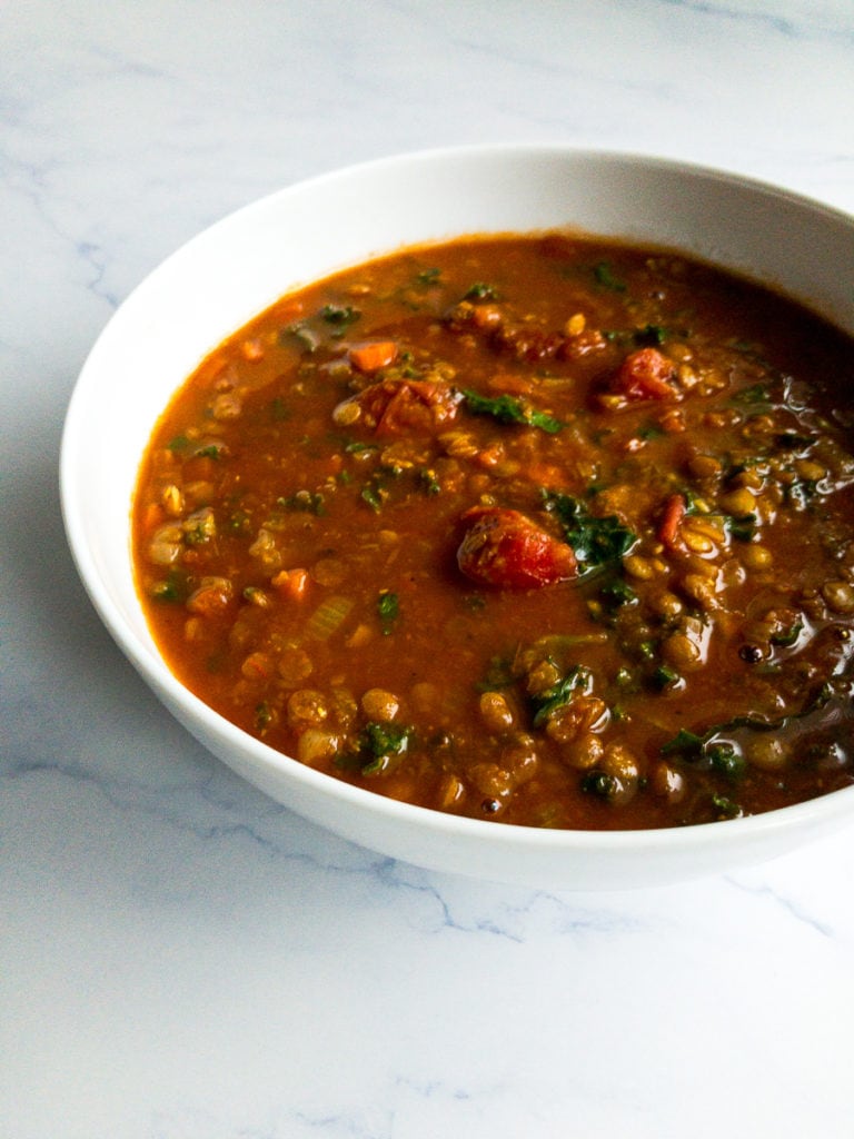vegetable lentil soup in a white bowl