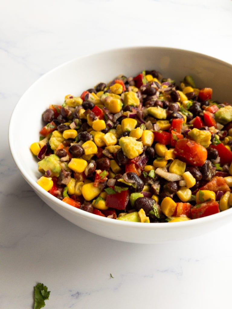 black bean and corn salad in a white bowl