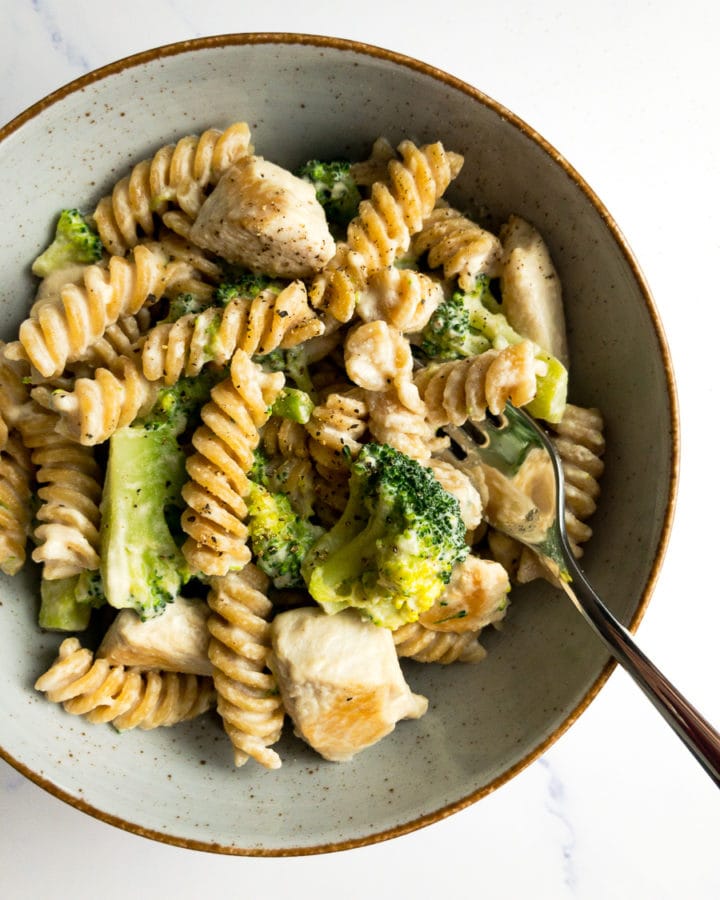 healthy chicken broccoli Alfredo in a bowl with a fork