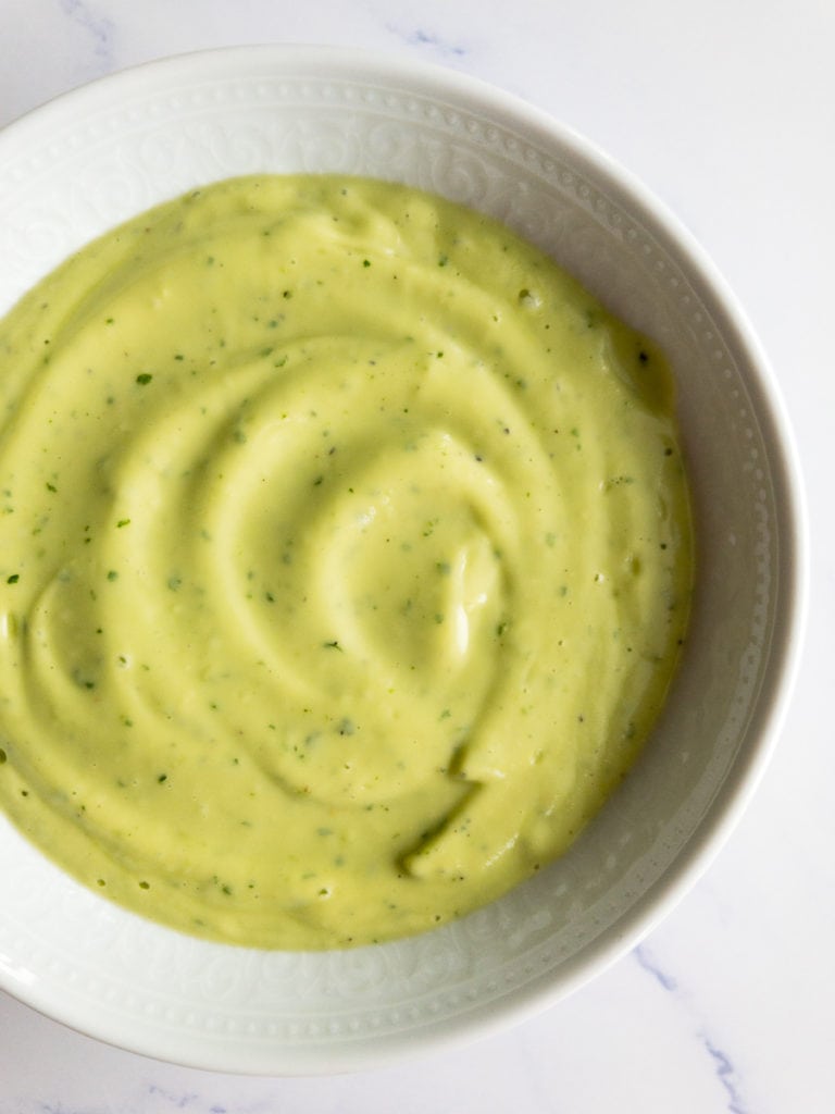 avocado lime dressing in a small white bowl