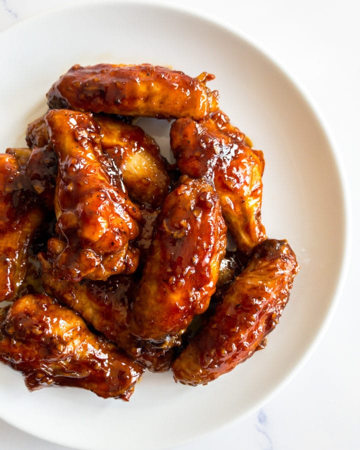 honey garlic chicken wings on a white plate