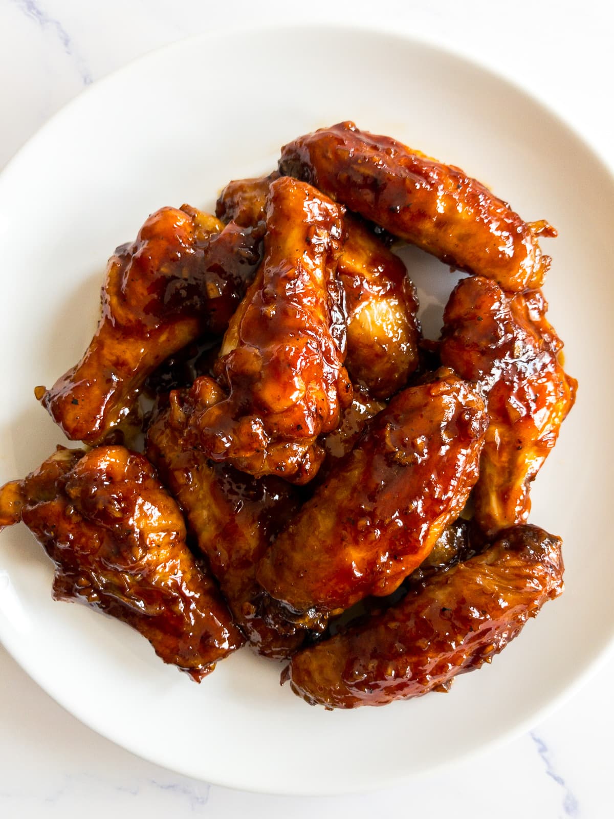 honey garlic chicken wings on a white plate