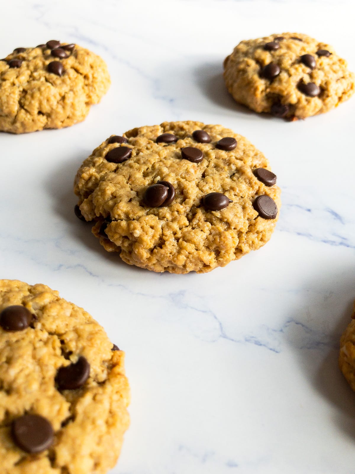 four peanut butter oatmeal chocolate chip cookies on a table