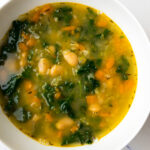 white bean and kale soup in a white bowl