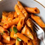 penne alla vodka with chicken in a bowl