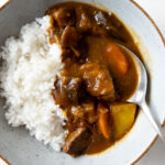 Japanese beef curry and white rice in a bowl with a spoon