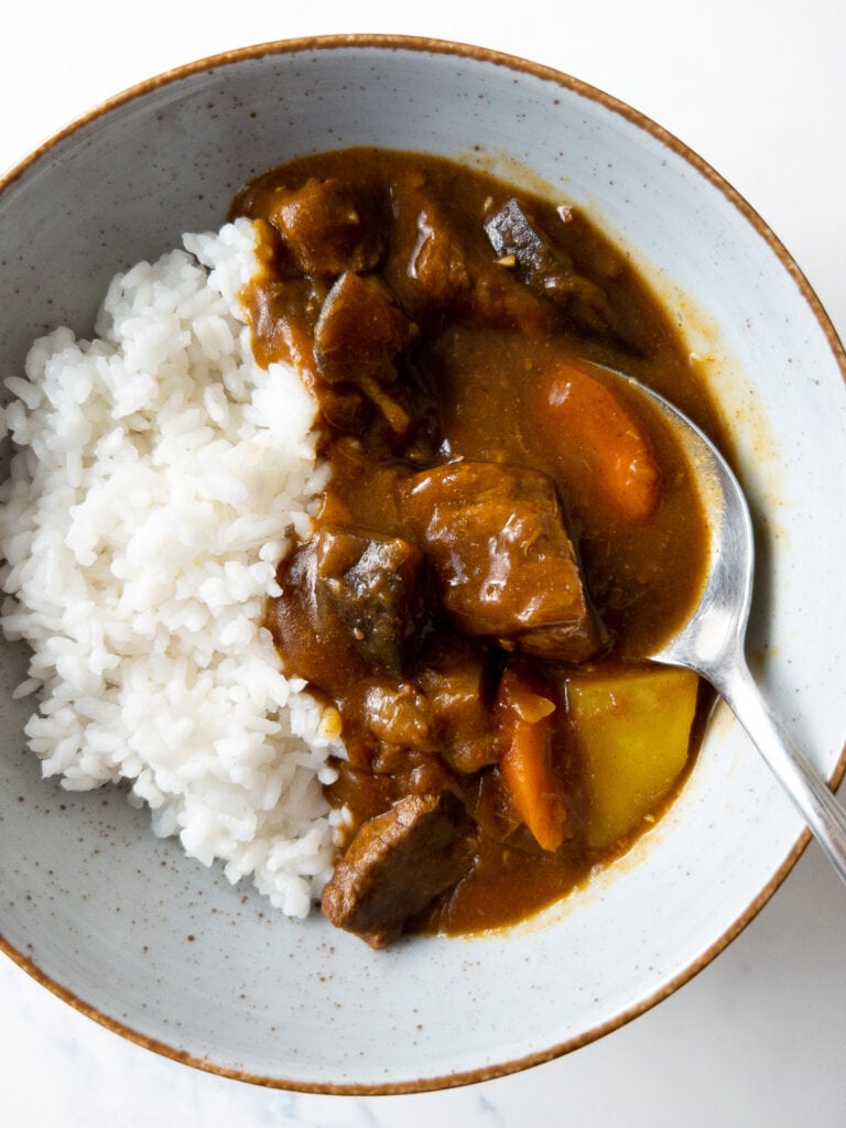 Japanese beef curry and white rice in a bowl with a spoon
