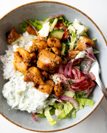 greek-style chicken bowl with a fork