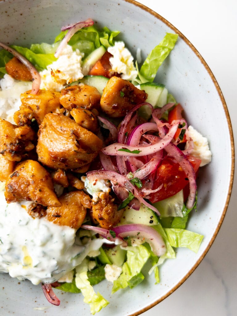 greek-style chicken bowl on a table