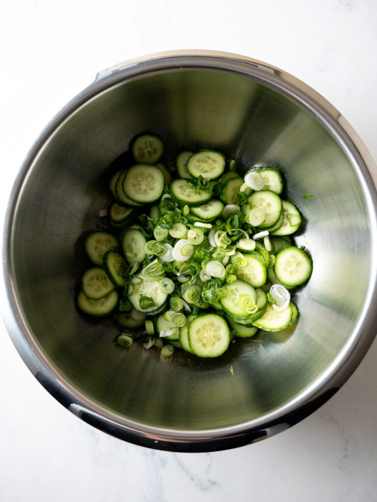 all ingredients for Korean cucumber salad (oi muchim) in a large mixing bowl