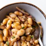 Turkish white bean salad in a bowl with a spoon