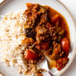 turkish moussaka on a plate with rice and a fork