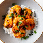 air fryer shrimp served over white rice in a bowl