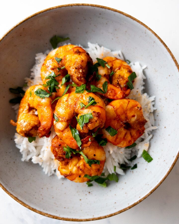air fryer shrimp served over white rice in a bowl