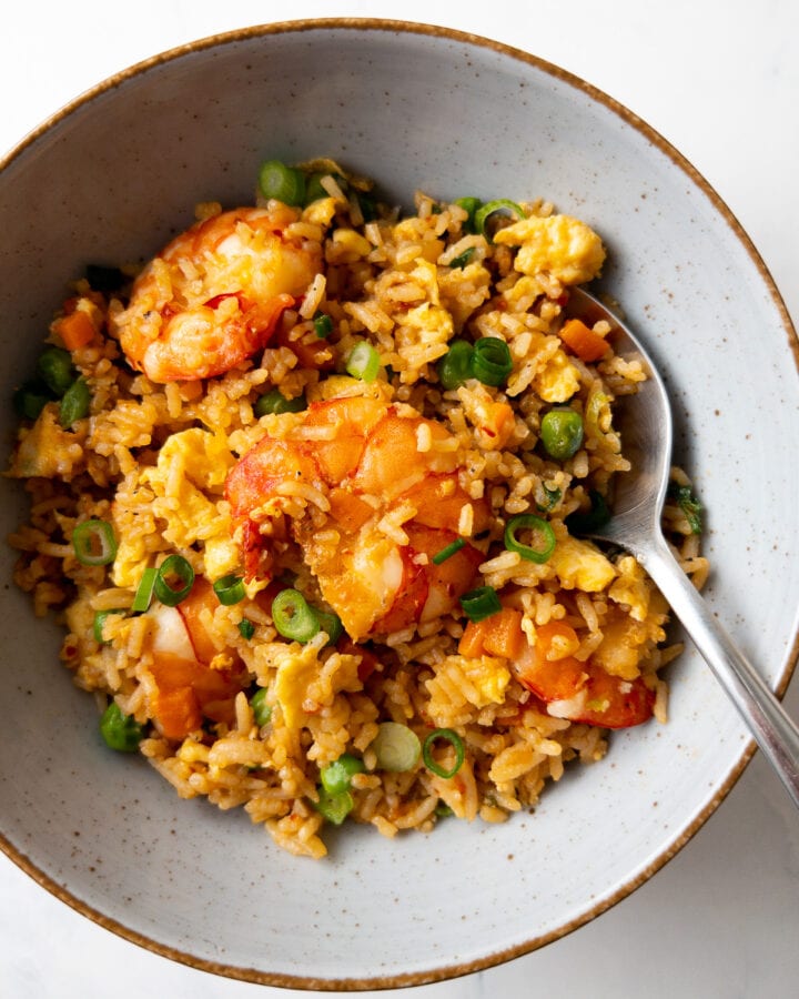 shrimp fried rice in a bowl with a spoon