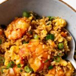 shrimp fried rice in a bowl with a spoon