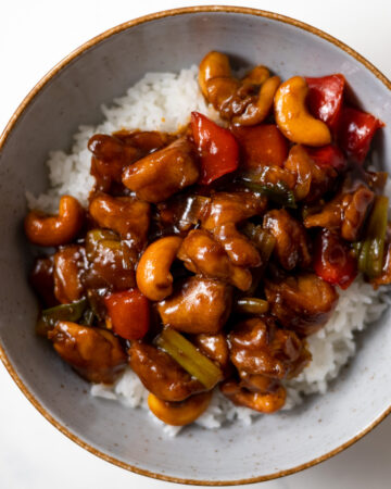 cashew chicken served over rice in a bowl