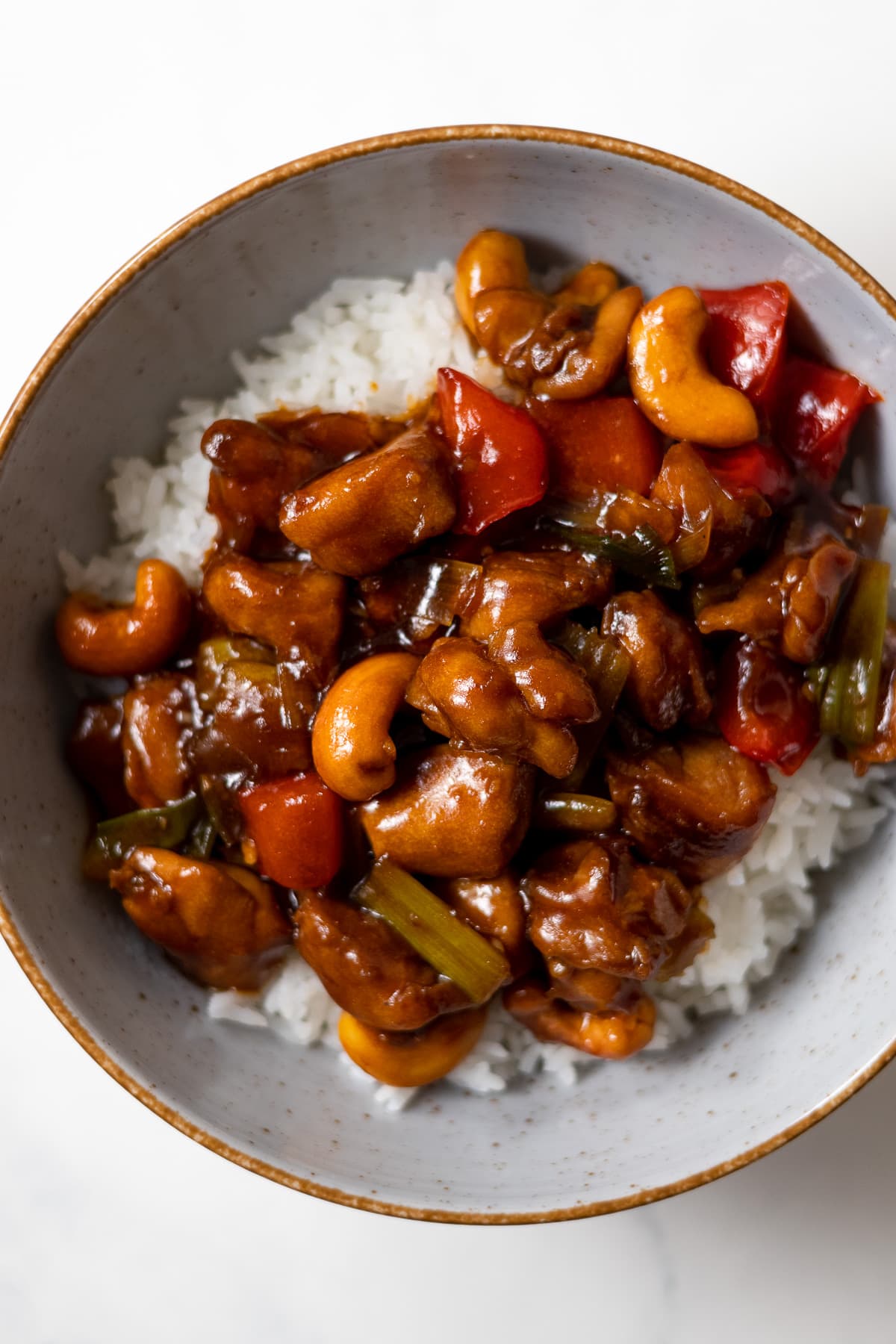 cashew chicken served over rice in a bowl