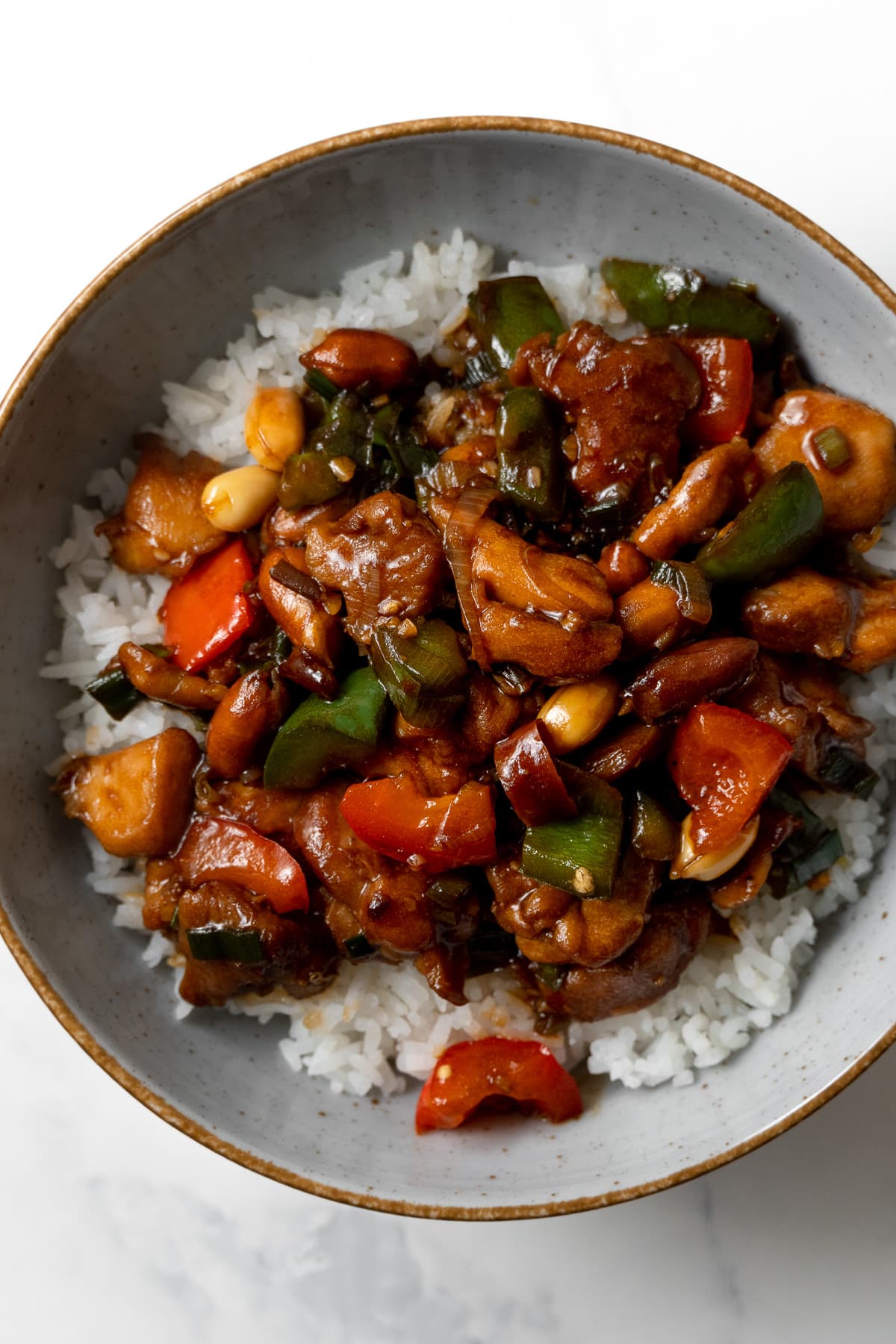 kung pao chicken served over rice in a bowl