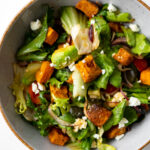 sweet potato salad garnished with feta cheese in a bowl