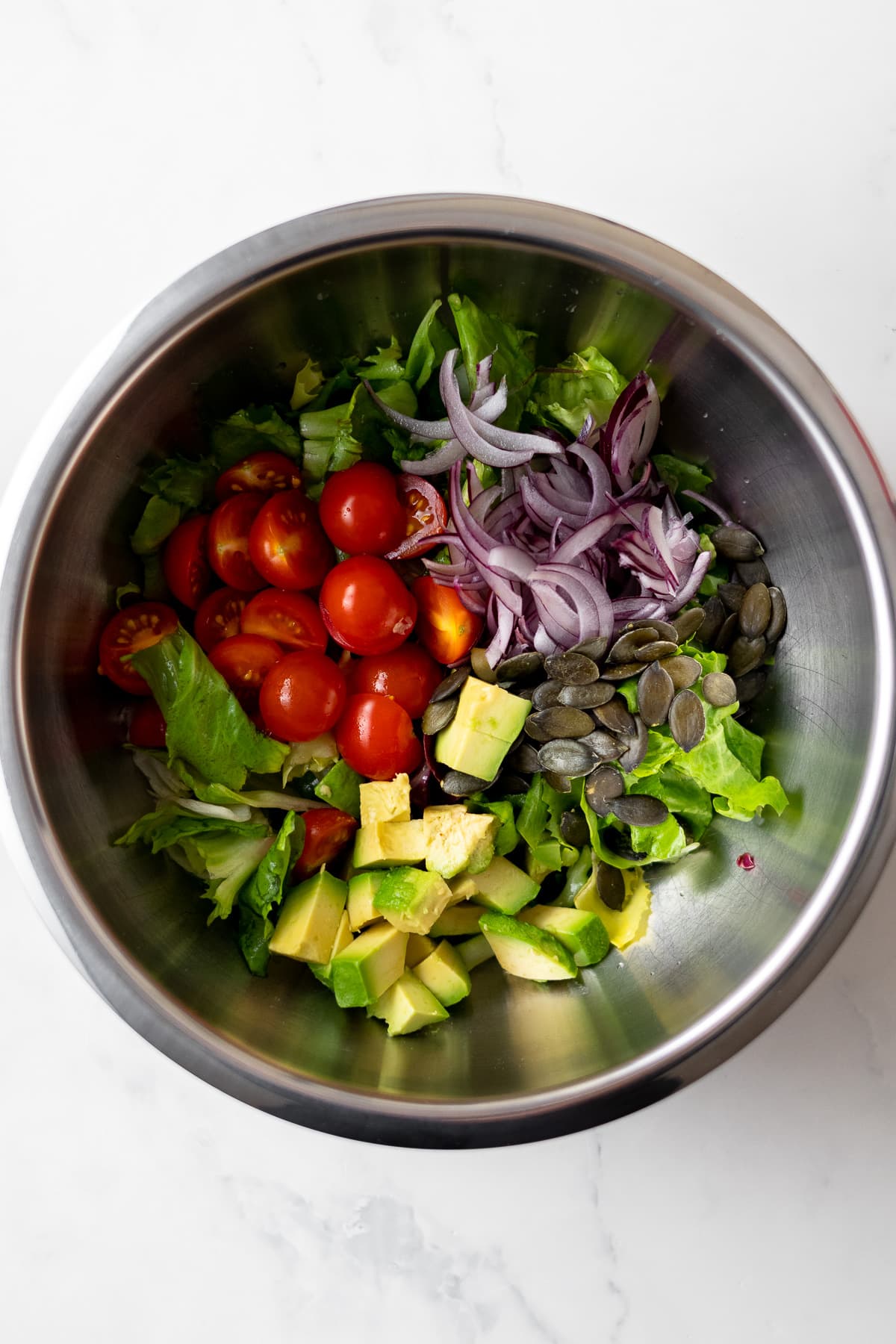 salad ingredients in a mixing bowl