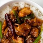 mongolian chicken served over white rice in a bowl