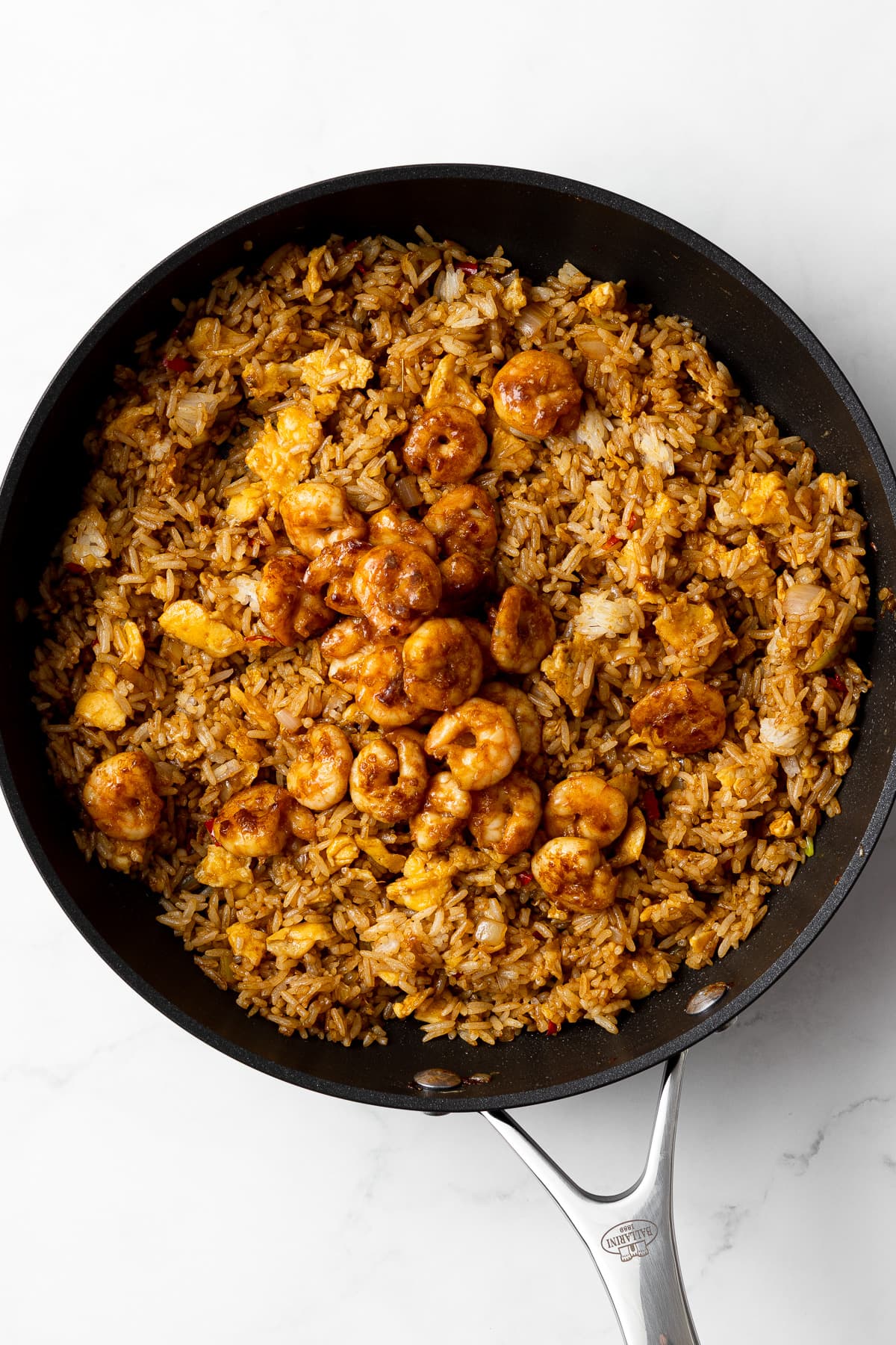 fried rice with added shrimp in a pan