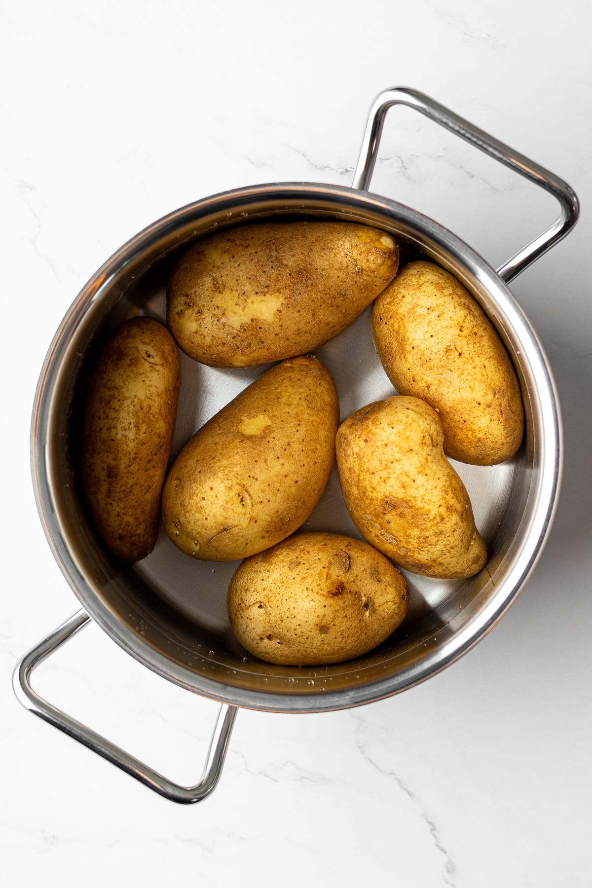 potatoes in a pot filled with salted boiling water