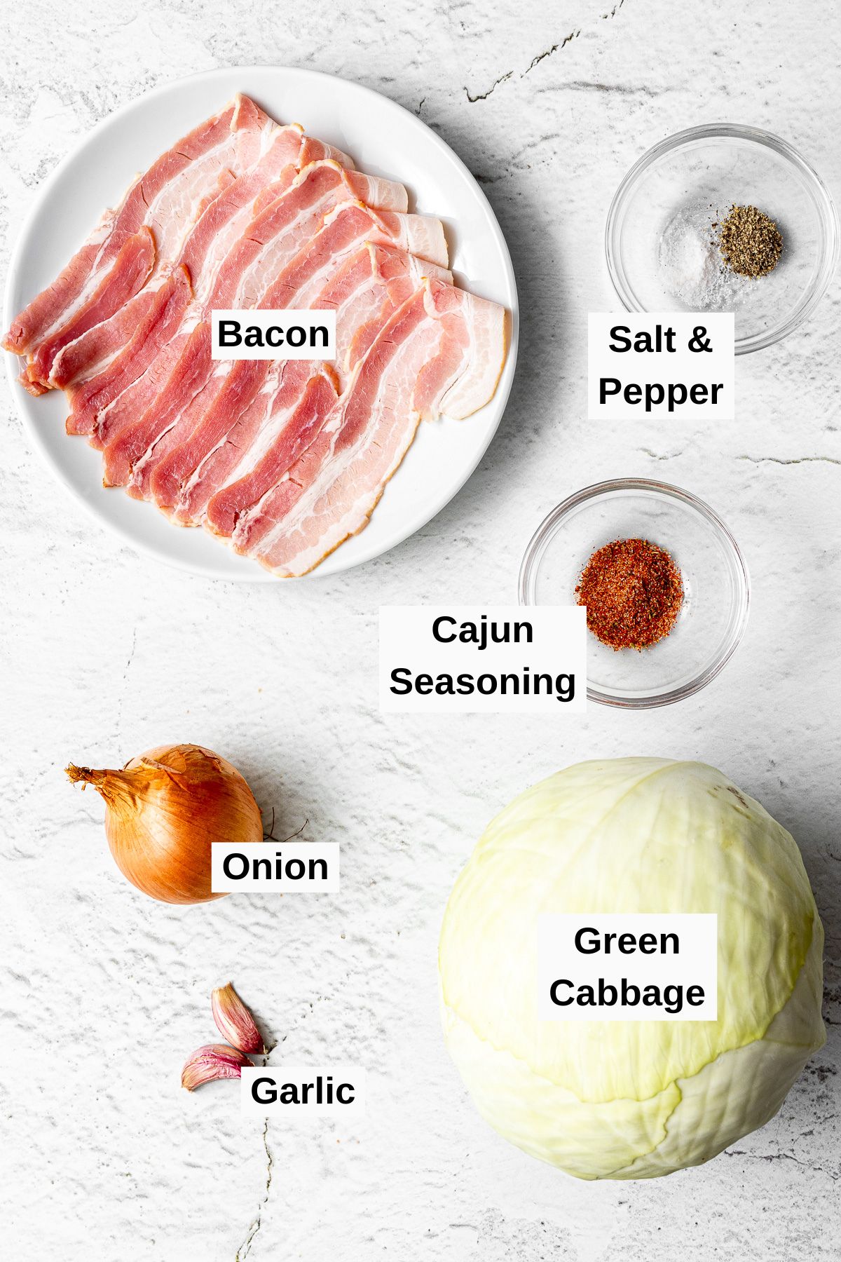 all ingredients for fried cabbage with bacon and onions on a table