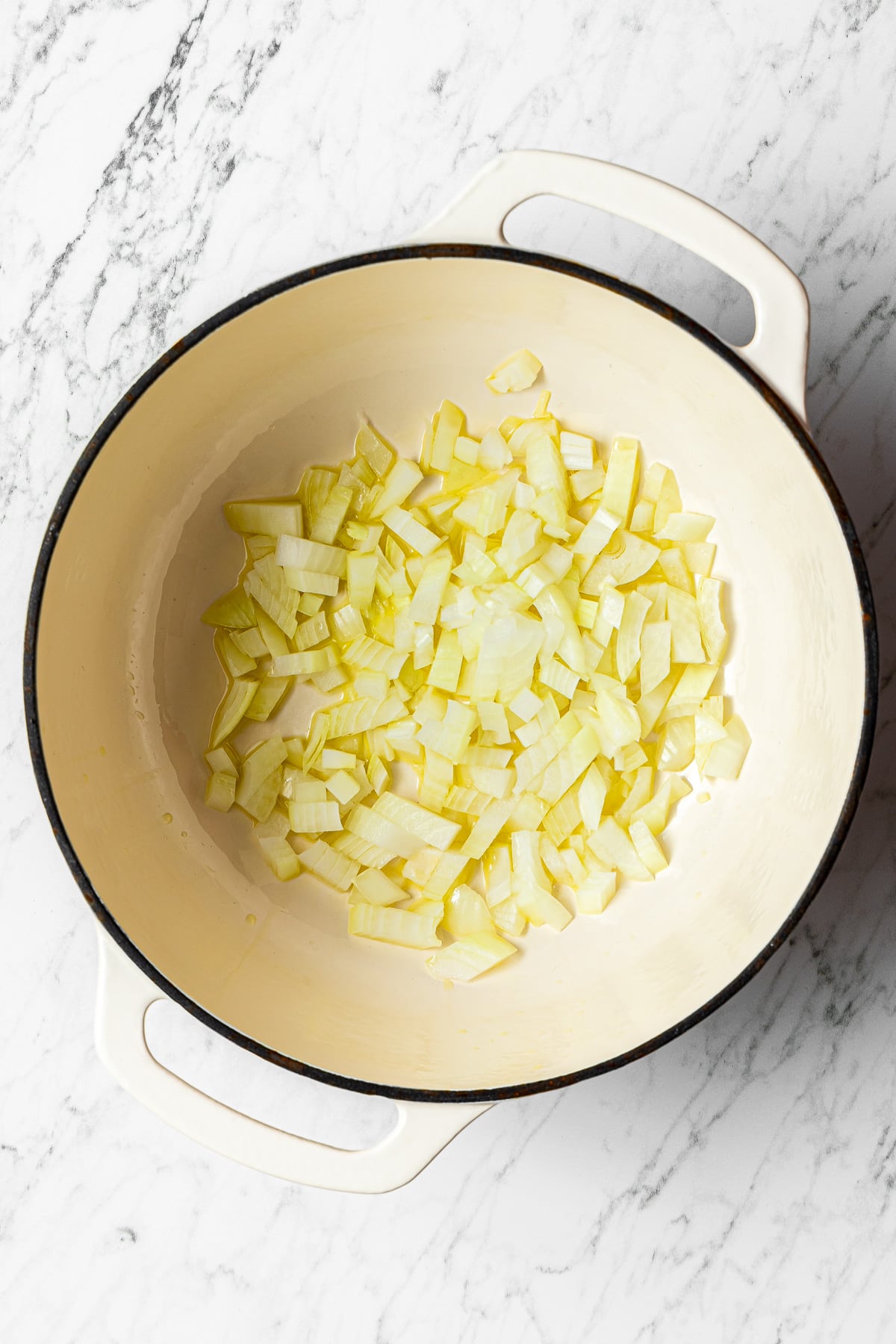 diced yellow onion with some olive oil in a pot