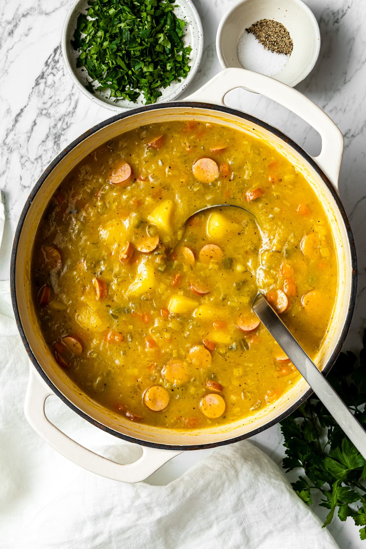 german potato soup in a pot with a soup ladle