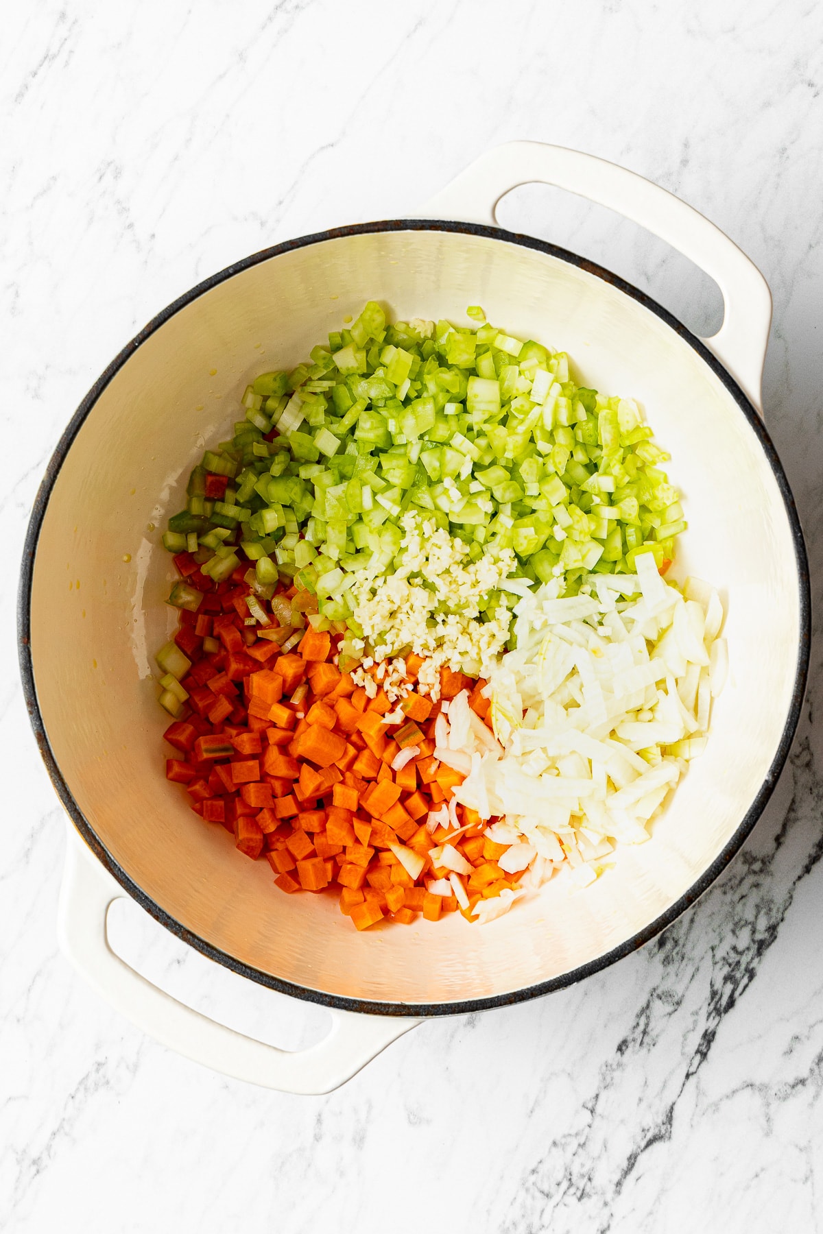 chopped vegetables and aromatics in a pot