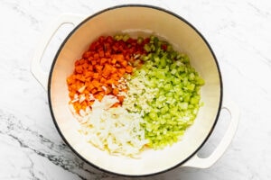 chopped vegetables and aromatics in a pot