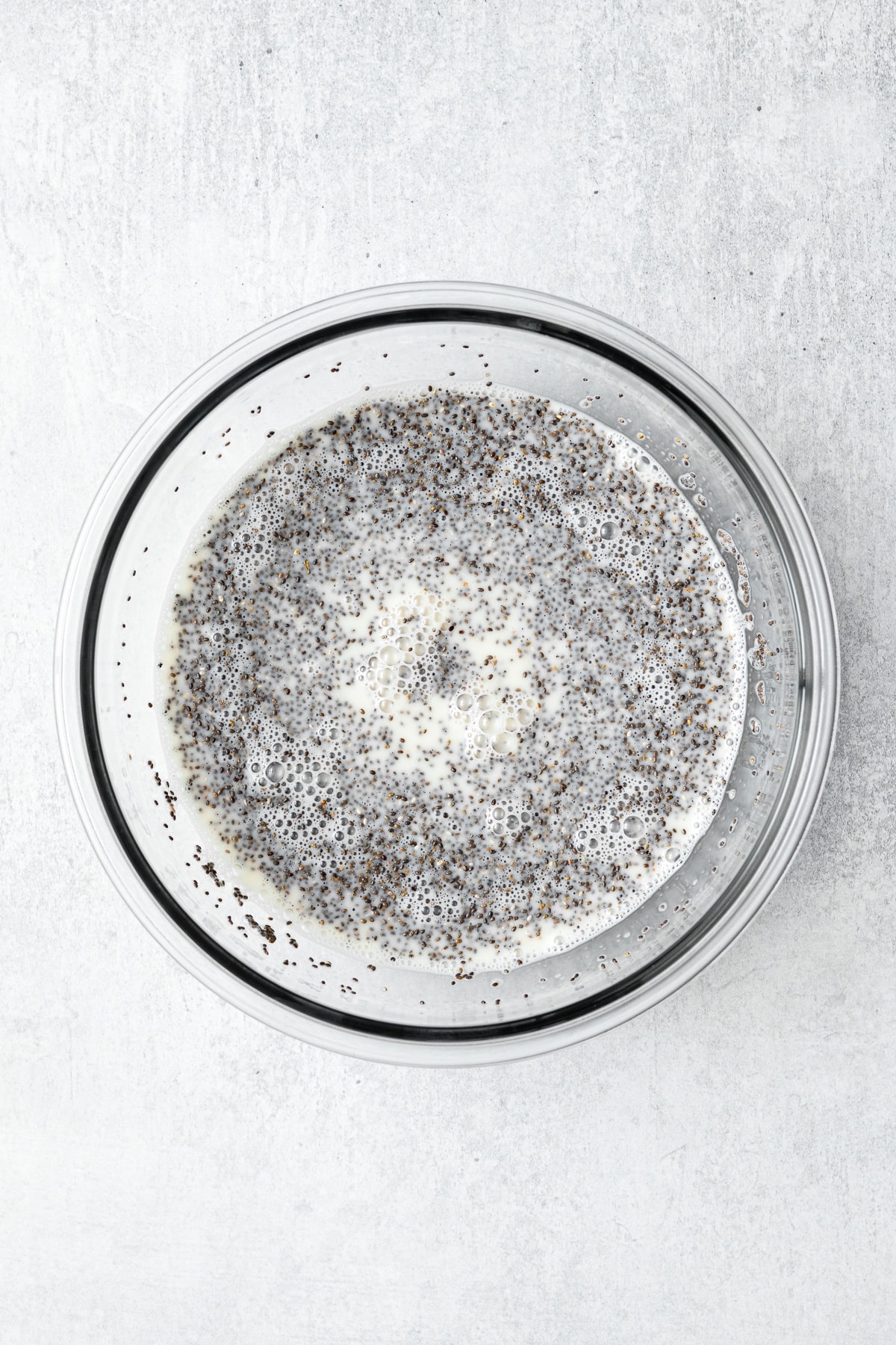 all ingredients for banana chia pudding whisked together in a large mixing bowl