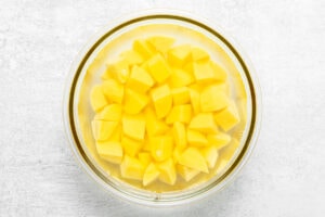cubed potatoes in a bowl filled with water