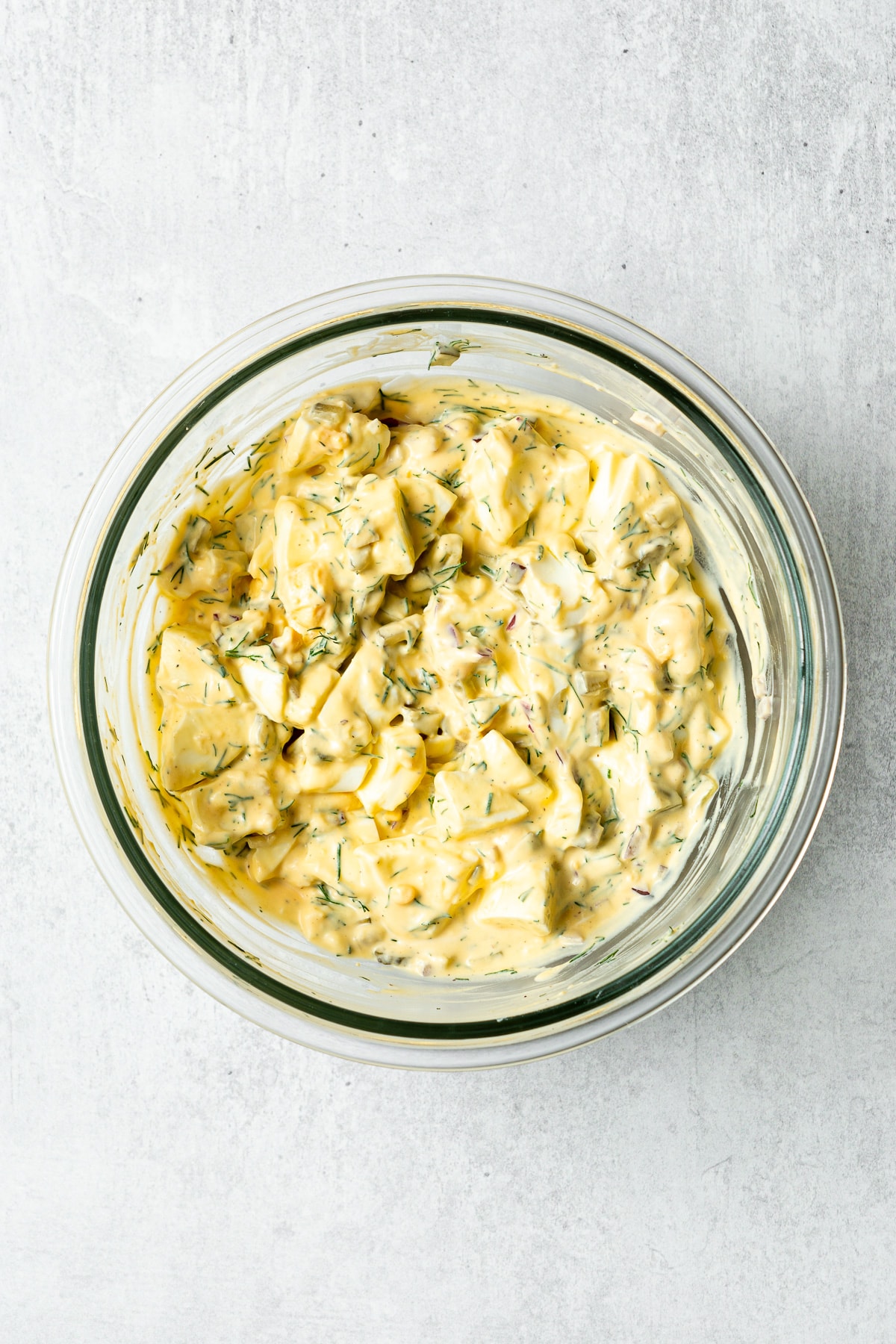 dill pickle egg salad in a mixing bowl