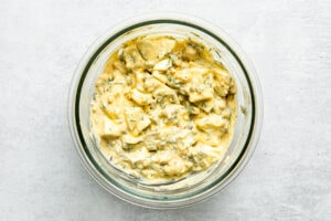 dill pickle egg salad in a mixing bowl