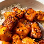 air fryer bang bang salmon bites served over fluffy white rice in a bowl