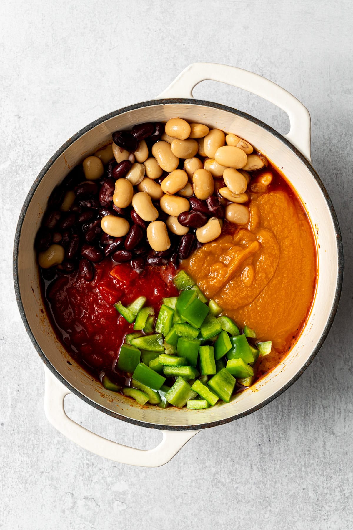 all the ingredients for beef pumpkin chili in a large pot