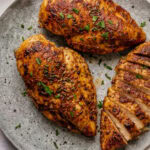 three air fryer chicken breasts on a plate